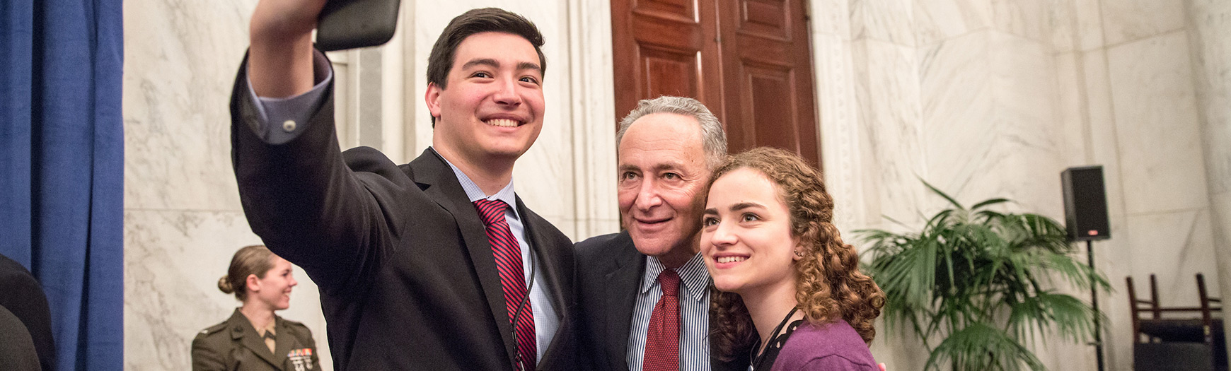 Senator Chuck Schumer (D-NY) takes a selfie with New York delegates at the USSYP Senate reception, Washington, DC